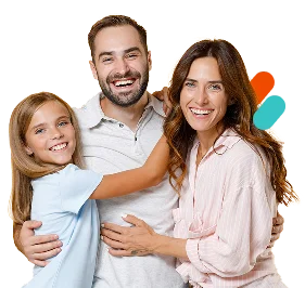 A smiling family with a father, mother, and daughter hugging each other in front of a blue and purple background.
