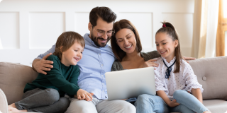 Family reviewing health plan options on a laptop, learning how health coverage premiums and deductibles work together