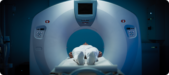Female Patient Lying Down on a CT or MRI Scan Bed While it Scans her Brain. Footage In Medical Laboratory or Healthcare Facility.