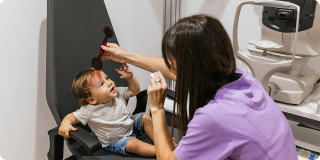 Pediatric eye doctor examines a young child during a developmental vision screening.