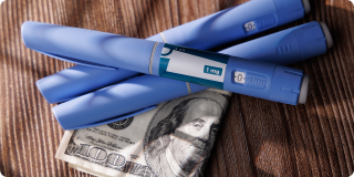 GLP-1 injection pens resting on U.S. currency, representing GLP-1 insurance costs and coverage.