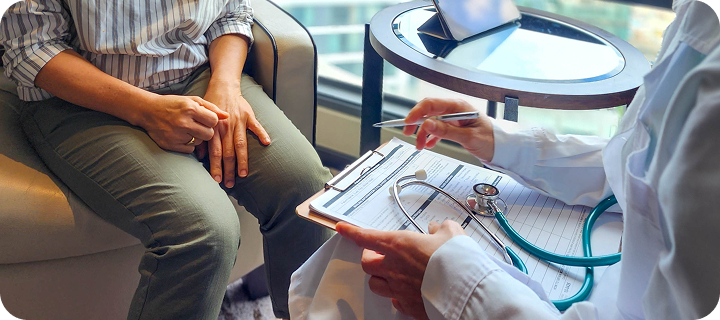 Patient discussing health insurance and medical care options with a healthcare provider.