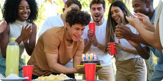 Young adults celebrating a birthday, representing the life change of turning 26 and reviewing Coverage Fox health insurance.